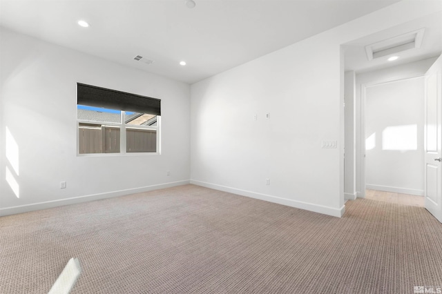 spare room featuring light colored carpet