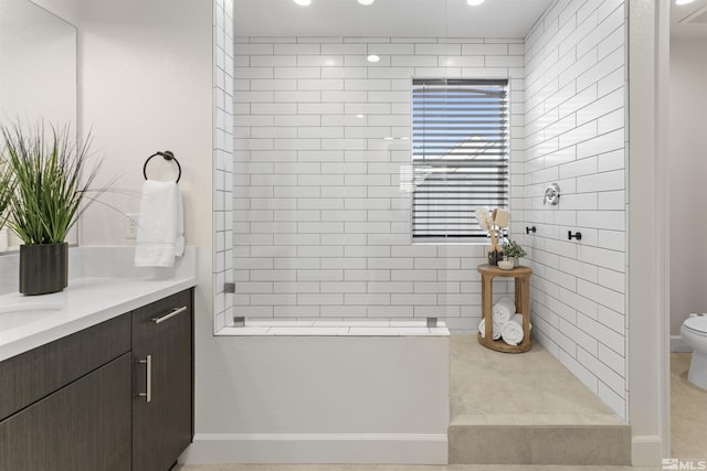 bathroom with toilet, a walk in shower, and vanity