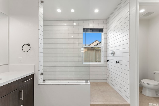 bathroom with vanity, tile patterned flooring, and toilet