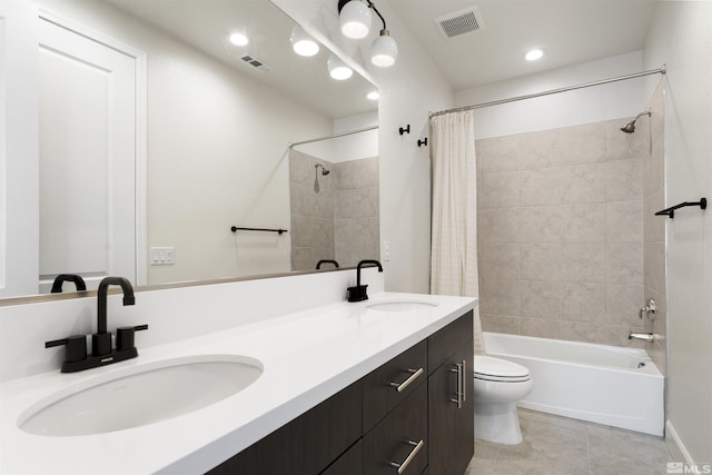 bathroom with visible vents, toilet, a sink, and shower / bath combo