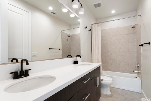 full bathroom featuring vanity, shower / bath combo with shower curtain, toilet, and tile patterned floors