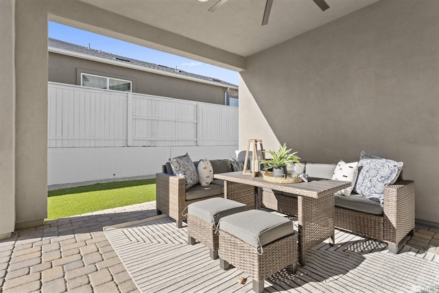 view of patio / terrace featuring ceiling fan and fence