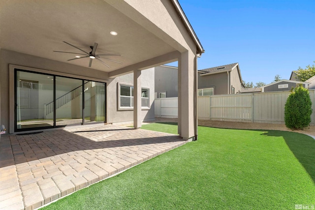 view of yard featuring ceiling fan and a patio area