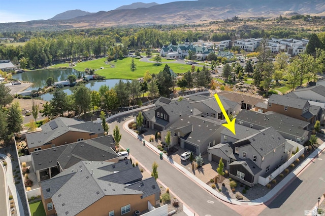 birds eye view of property featuring a water and mountain view