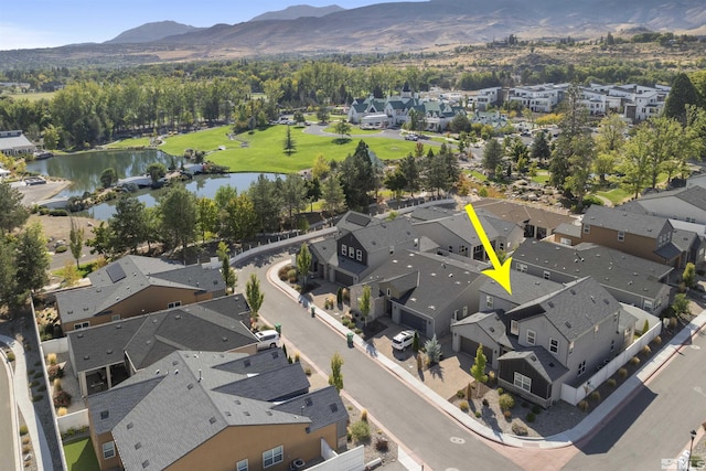 drone / aerial view with a residential view and a water and mountain view