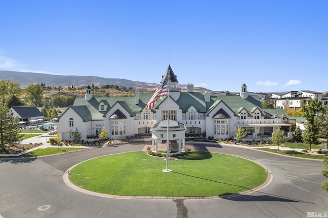 view of building exterior with a residential view and a mountain view