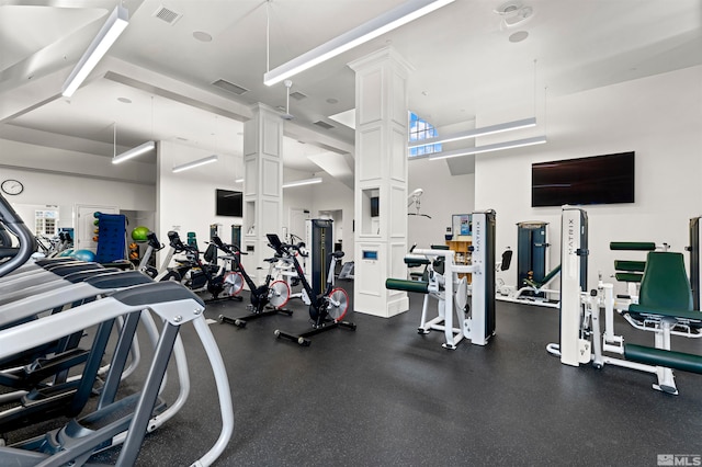 gym featuring ornate columns