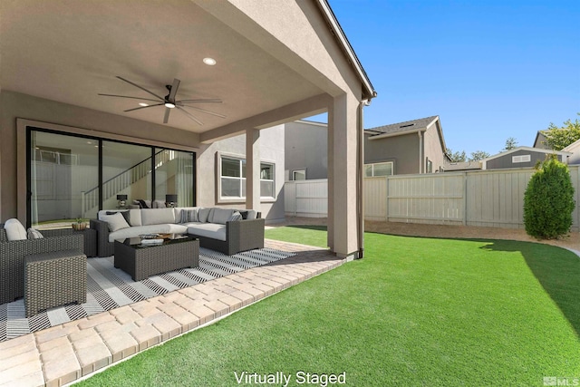 view of yard featuring a patio, an outdoor living space, and ceiling fan