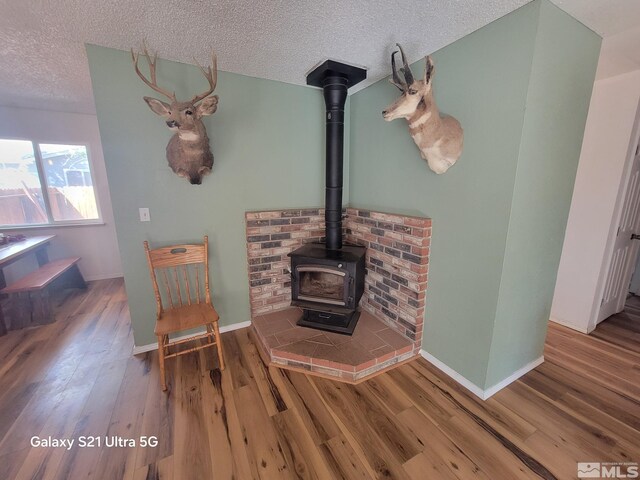 unfurnished living room with hardwood / wood-style floors and a textured ceiling