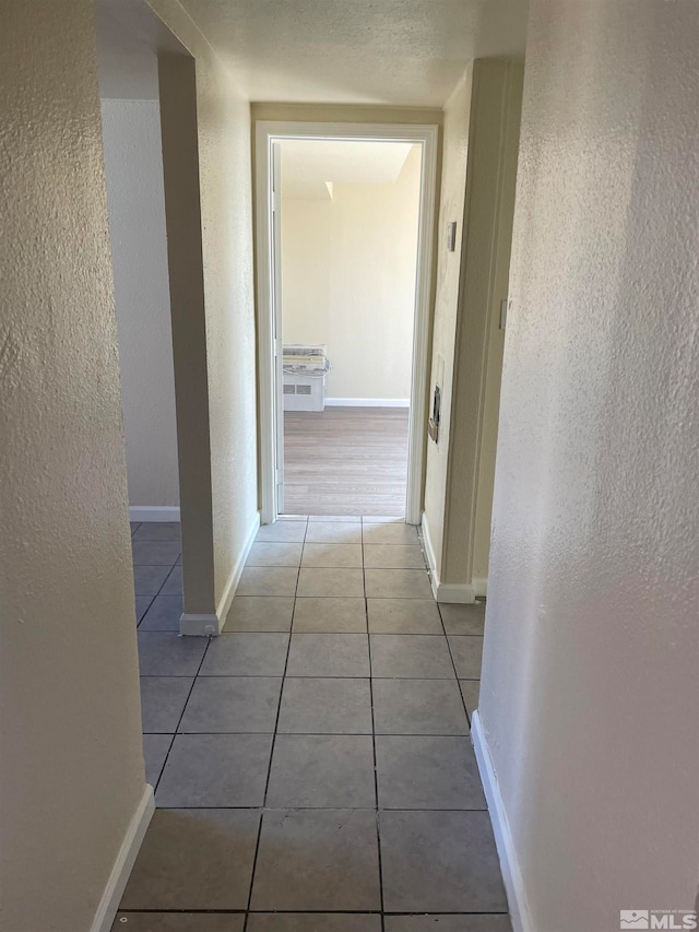 hallway with light tile patterned floors