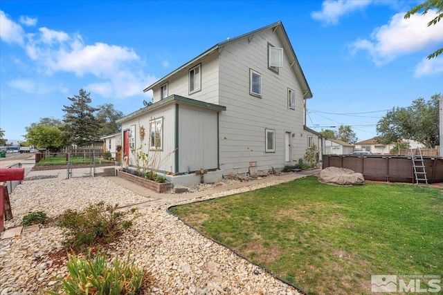 rear view of property with a lawn