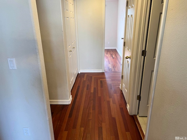 hallway with dark hardwood / wood-style flooring