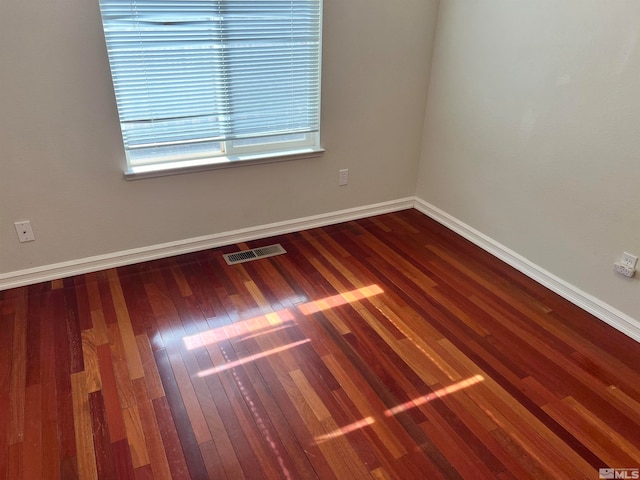 empty room with hardwood / wood-style floors