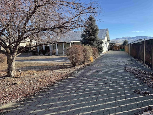 view of property exterior with a mountain view