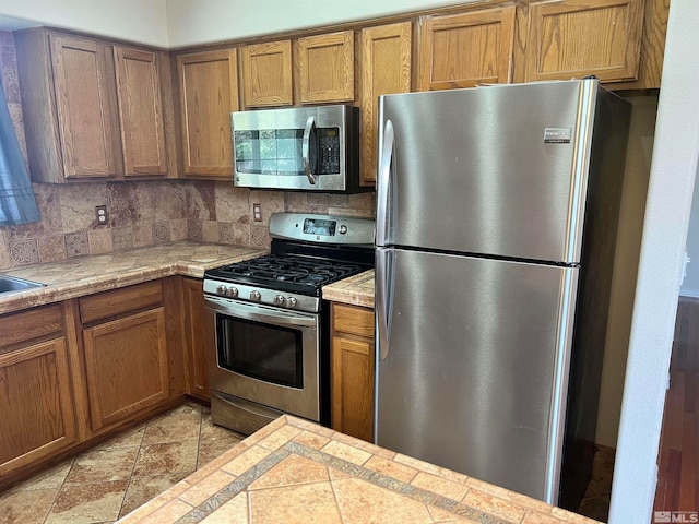 kitchen with decorative backsplash and stainless steel appliances