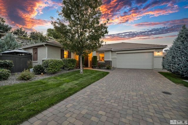 view of front of house featuring a yard and a garage