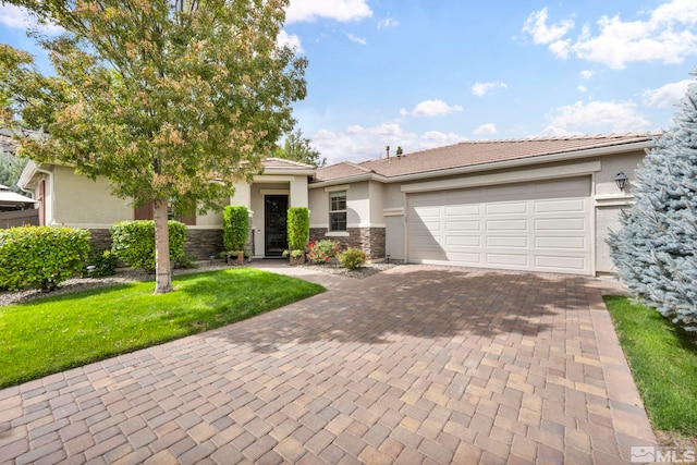 view of front of house featuring a garage and a front lawn