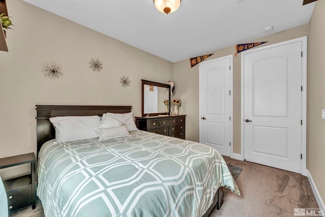 bedroom featuring light colored carpet