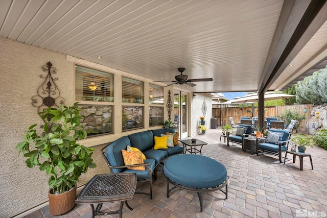 view of patio / terrace with an outdoor living space and ceiling fan