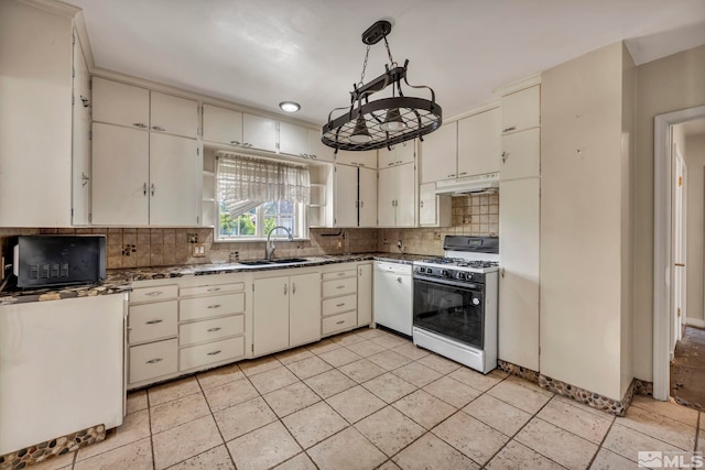 kitchen featuring white appliances, sink, pendant lighting, and tasteful backsplash