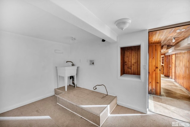 laundry area featuring hookup for a washing machine and wooden walls