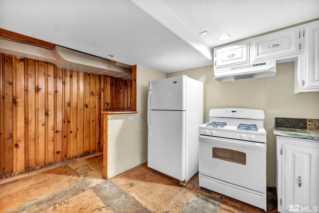 kitchen with a textured ceiling, white appliances, and white cabinetry