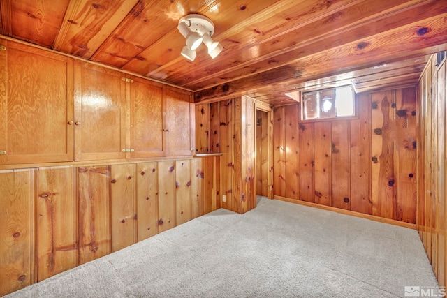 basement with wooden walls, carpet flooring, and wooden ceiling