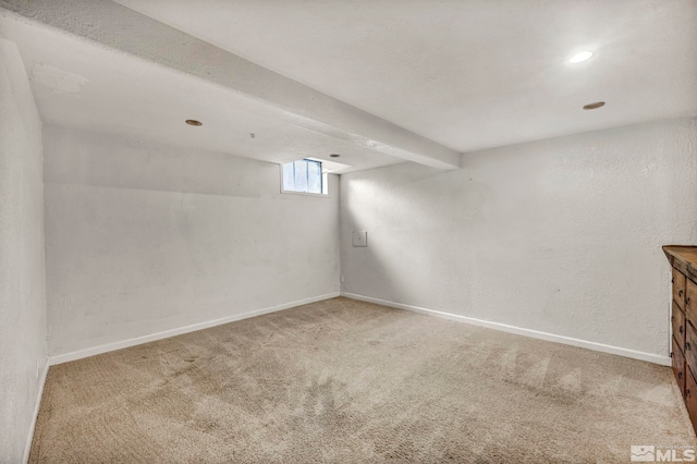 basement featuring light carpet