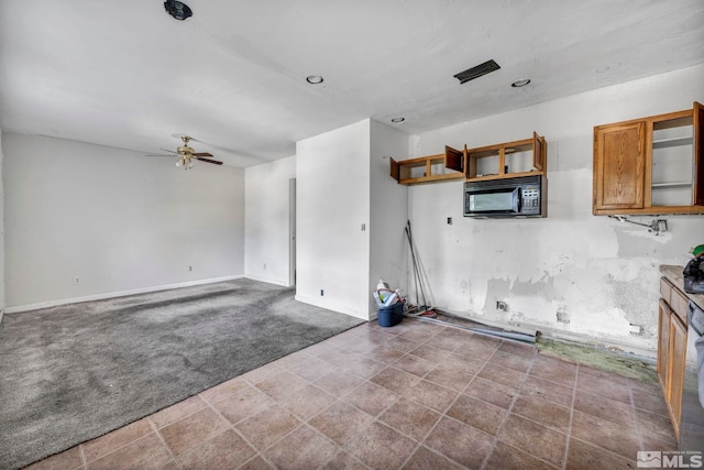 interior space with carpet and ceiling fan