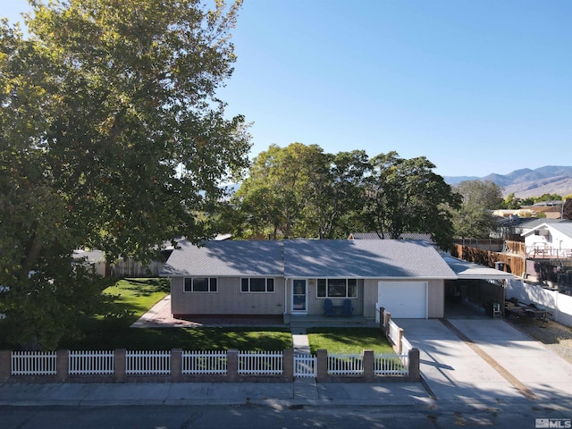 view of front of property featuring a mountain view and a garage