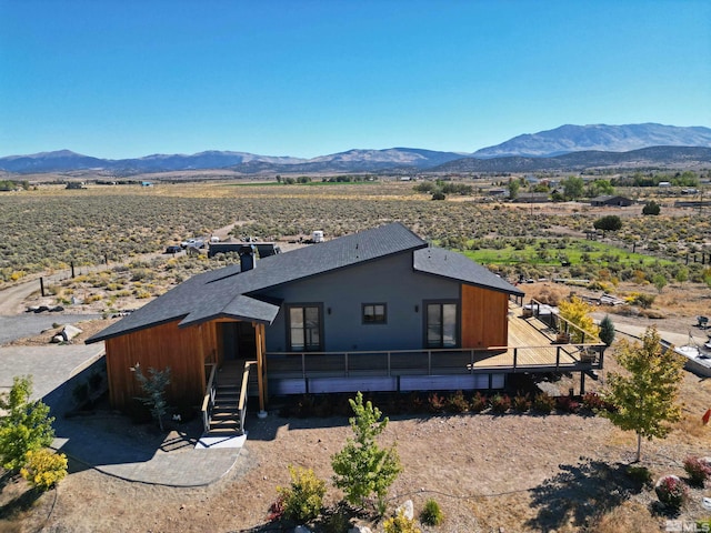 exterior space with a deck with mountain view