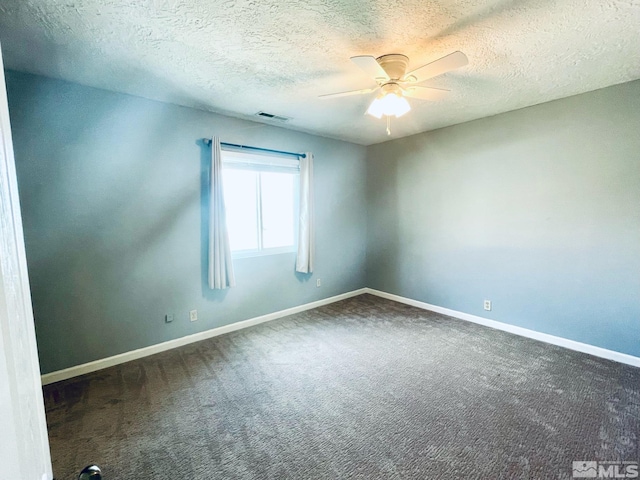 carpeted empty room featuring ceiling fan and a textured ceiling