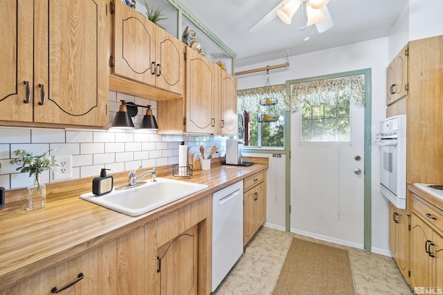 kitchen with ceiling fan, sink, white appliances, and tasteful backsplash