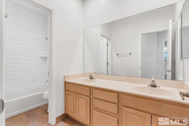 full bathroom with vanity, tiled shower / bath combo, toilet, and tile patterned floors