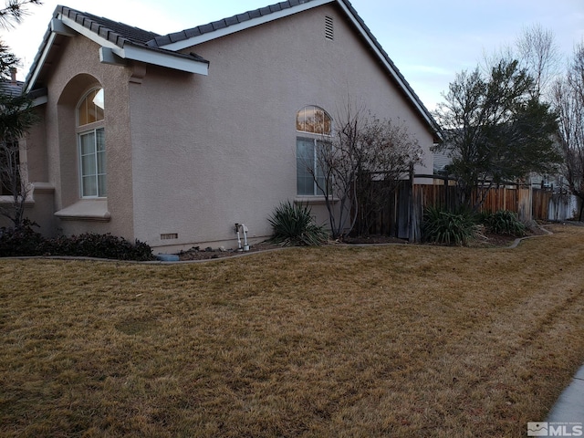 view of property exterior with a lawn