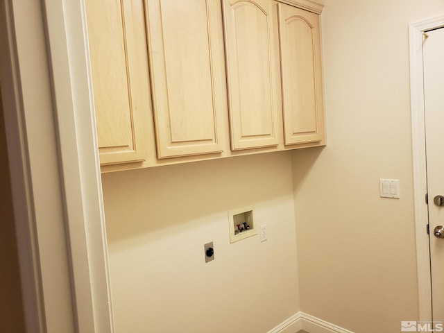 laundry room featuring hookup for a washing machine, hookup for an electric dryer, and cabinets