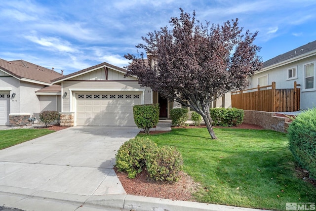 view of front facade featuring a front yard and a garage