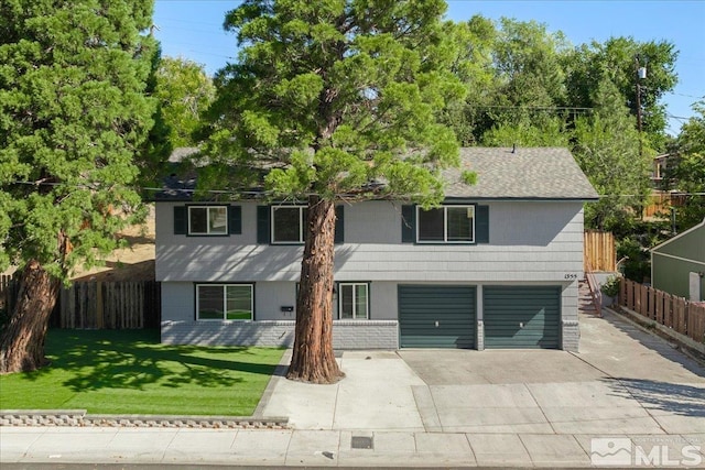 view of front of property featuring a garage and a front yard