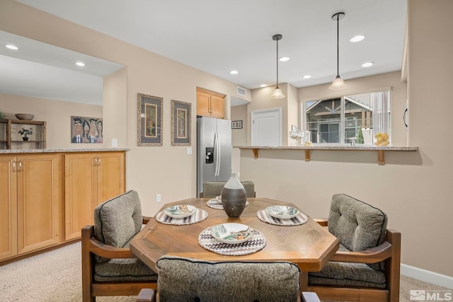 view of carpeted dining space