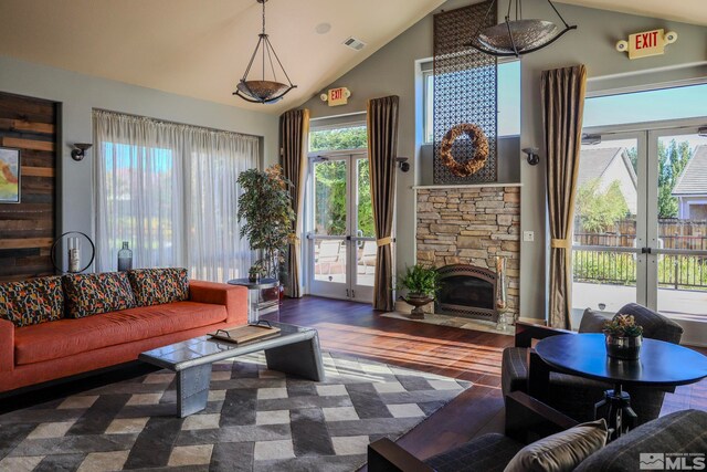 living room with plenty of natural light, french doors, and dark hardwood / wood-style flooring