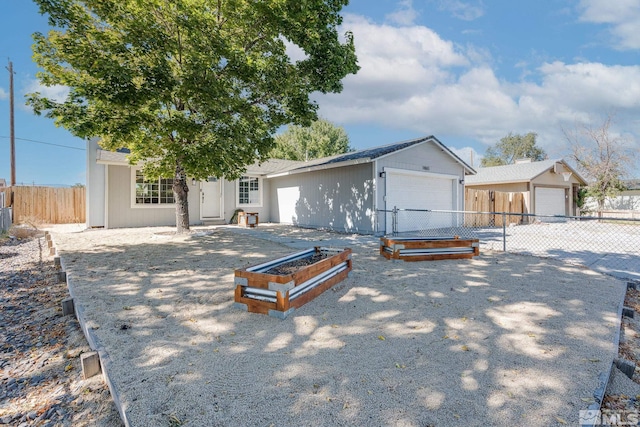 ranch-style house with a garage and an outbuilding