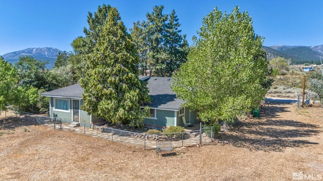 back of house with a mountain view