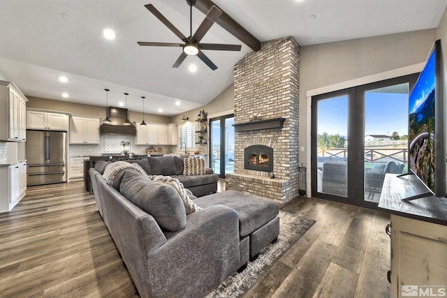 living room with ceiling fan, beamed ceiling, high vaulted ceiling, a fireplace, and dark hardwood / wood-style flooring