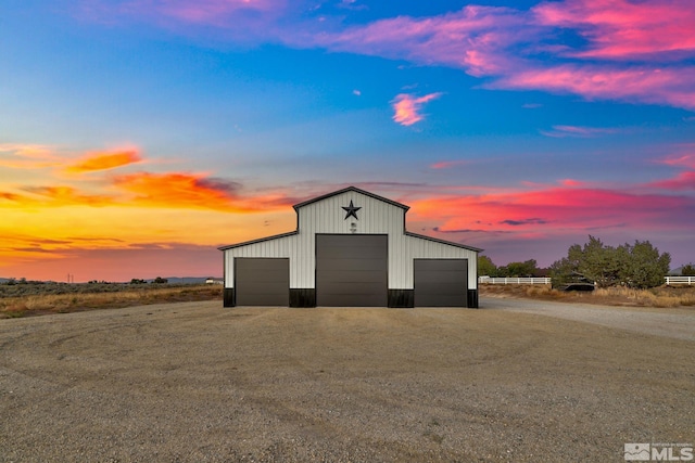 outdoor structure at dusk featuring a garage