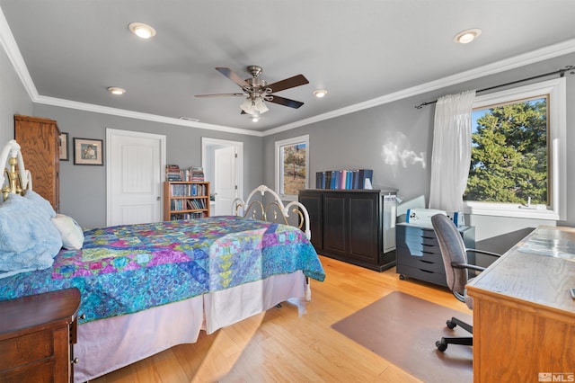 bedroom with ornamental molding, light wood-type flooring, and ceiling fan