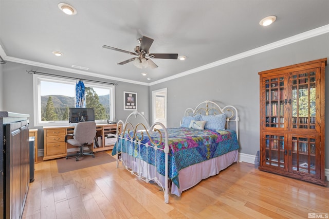 bedroom featuring ceiling fan, light wood-type flooring, and crown molding