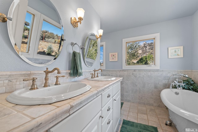 bathroom featuring a tub, tile walls, and vanity