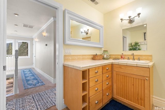 bathroom featuring ornamental molding and vanity