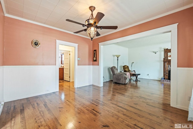 unfurnished room featuring crown molding, hardwood / wood-style flooring, and ceiling fan