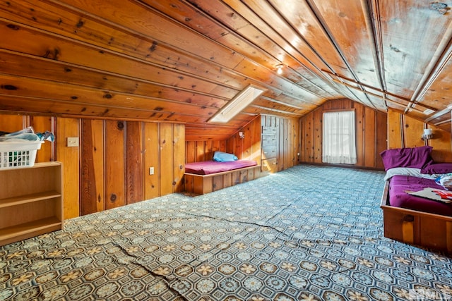 additional living space featuring wooden walls, wood ceiling, and vaulted ceiling with skylight